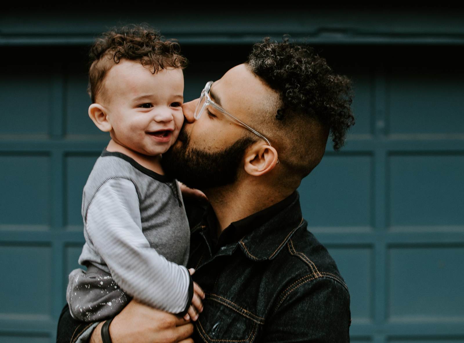 A caregiver holding a smiling young child